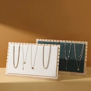Solid wood jewelry display stand with white and green leather pads for necklaces