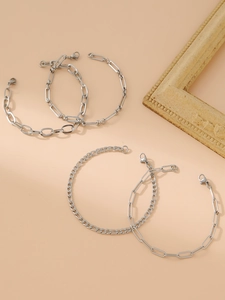 Detail of five silver-tone stainless steel chains in paperclip and curb link styles