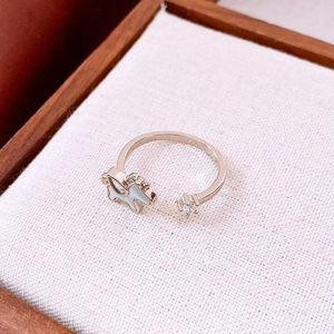 Detailed close-up of a silver open ring featuring a white enamel horse and zircon stone