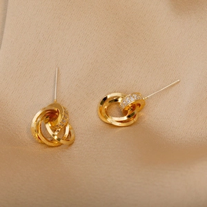 Elegant gold triple interlocking hoop earrings with micro-pave zircons on silk background