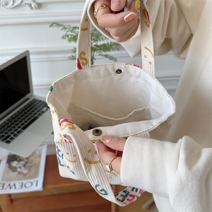 Close-up of corduroy tote bag interior with metal snap button and inner pocket