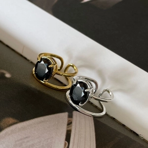 Detail view of gold and silver S925 rings featuring large oval black zircon stones