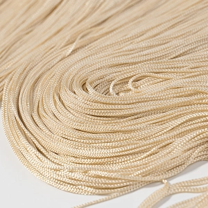 Detailed close-up showing high-quality golden tassel fringe with silky texture and shine
