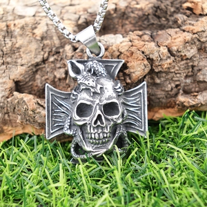 Gothic stainless steel skull and snake pendant with cross on natural wood background