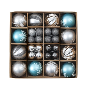 Detail of 16 assorted Christmas balls in blue and silver styles inside a gift box