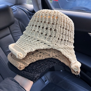 Close-up of hollow knit bucket hats in beige, khaki, and black with breathable patterns