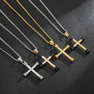 Detail view of four ribbed cross pendants in gold and silver finishes on dark background