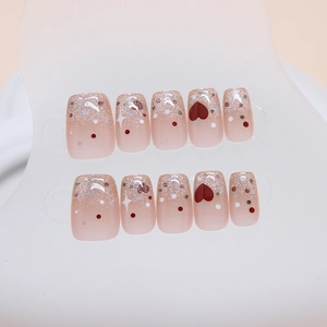 Pink cat-eye press-on nails with silver glitter gradient, heart and star patterns