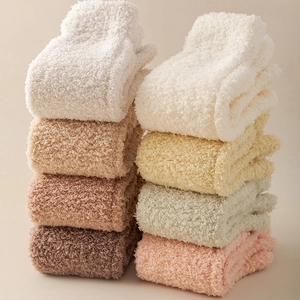 Close-up of soft thick coral fleece winter socks in multiple warm pastel colors