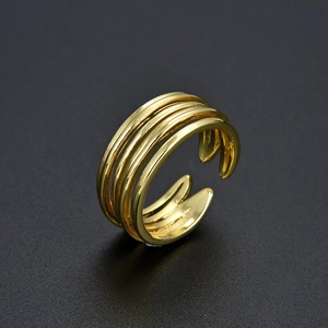 Detailed macro shot of a gold multi-layer adjustable ring with a metallic polished finish