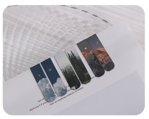 Detailed view of artistic magnetic bookmarks with sky and forest landscape designs