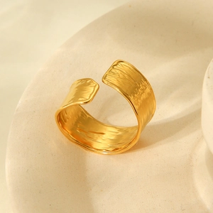 Close-up of 18K gold plated stainless steel open ring with hammered texture finish