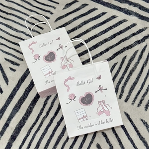 Detail of pink ballet girl and shoes print on white kraft gift paper bag with rope handle