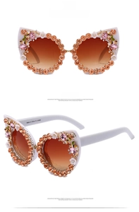 Detailed front and side view of cat eye sunglasses with rhinestones and floral accents