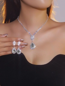 Detailed view of luxury silver teardrop rhinestone necklace and earrings bridal jewelry set
