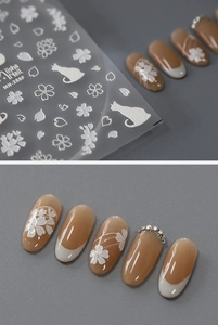 Detail of MN-288F nail stickers with white embossed flowers and cute cartoon cat motifs