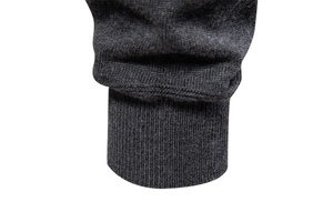 Detailed close-up of dark grey ribbed knit cuffs on high quality men's cardigan