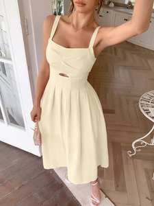 Detail of beige midi dress featuring a twist-knot bodice and waist cutout accents