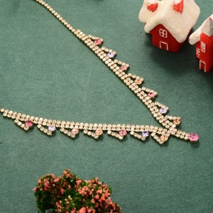 Elegant V-shaped gold necklace with colorful zircon and clear crystals in festive setting