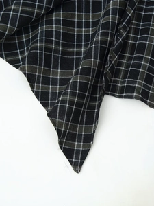 Dettaglio macro del tessuto scozzese bianco e nero con trama in cotone e lino plissettato