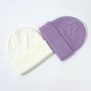 Pair of soft knitted baby beanies in white and purple for autumn and winter season