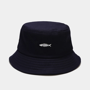 Close-up of navy cotton fisherman hat featuring white fishbone embroidery and stitching