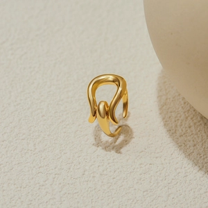 Macro shot of gold-plated lava-style ring showing fluid texture and metallic luster