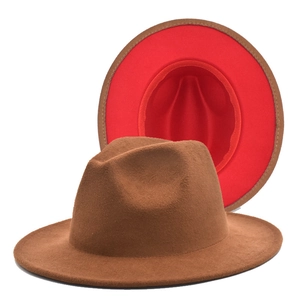 Detail of classic wide brim wool felt jazz hat with brown exterior and bright red lining