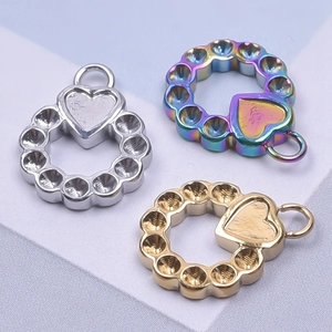 Polished stainless steel heart ring pendants in gold, silver, and rainbow finishes