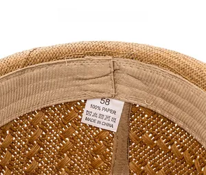 Detail of paper straw hat interior showing size label and breathable sweatband