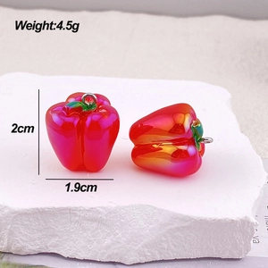 Macro view of chili-shaped red resin pendant with silver ring and size measurements