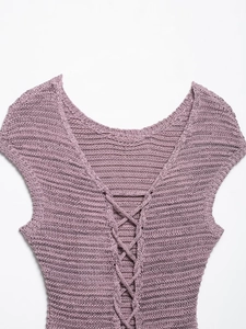 Macro detail of lavender knit vest with hollow crochet texture and lace-up neck design