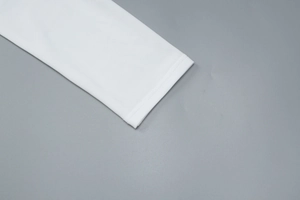 Close-up of delicate lace cuffs and fine stitching on a white long-sleeve T-shirt