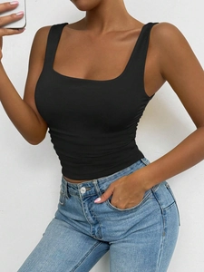 Detail of black slim-fit tank top with square neck in ribbed knit fabric via mirror selfie