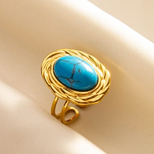 Detail of adjustable gold ring with oval blue turquoise stone and rope texture edge