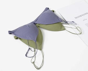 Detailed close-up of purple ribbed triangle bralette with thin straps and seamless design