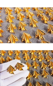Detailed view of gold irregular pleated earrings with artistic metal texture finish