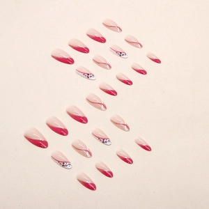 Fuchsia almond press-on nails with leopard patterns and gold glitter diagonal French tips