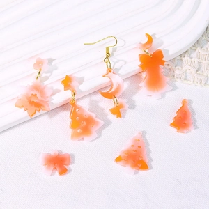 Christmas tree and snowflake acrylic earrings in orange and white gradient on lace