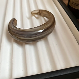 Translucent acrylic open bangle in brownish grey with marble texture effect