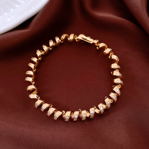 Detailed view of 18K gold twisted cuff bracelet with sparkling zircon on silk