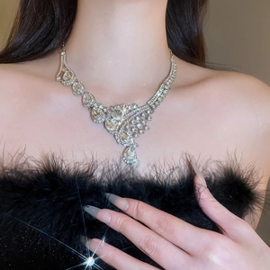 Elegant silver necklace with diamond teardrop pendant worn by a model in luxury style