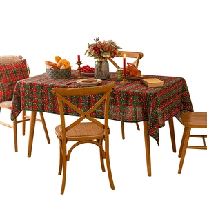 Classic red and green plaid tablecloth with snowflake prints for festive dining tables