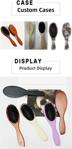 Detailed close-up of boar bristle hairbrush featuring a natural wood handle and oval head