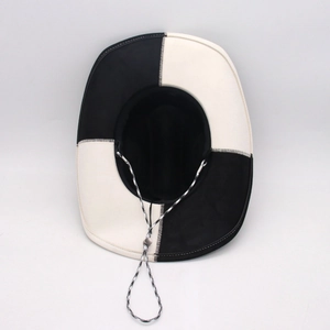 Detailed top view of black and white checkered cowboy hat with adjustable chin strap