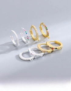 Macro detail of S925 sterling silver hoop earrings with colored cubic zirconia stones
