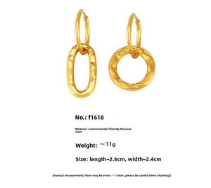 Detail of gold titanium steel earrings featuring geometric rings and hammer texture finish