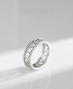 Detail of S925 sterling silver hollow heart ring with pave zircon stones and mirror reflection