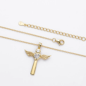 Macro shot of S925 silver angel wing cross pendant with clear zircon and lobster clasp