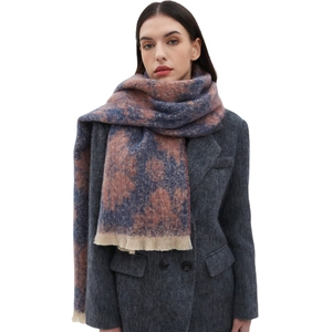 Blue and pink floral jacquard winter scarf with fringe trim worn with dark grey blazer
